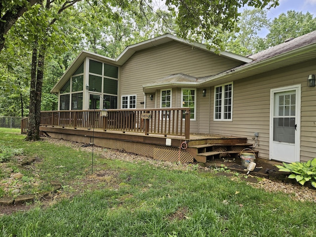9726 County Road 8530, West Plains, MO 65775 - back of property featuring a sunroom, a wooden deck, a lawn, and a shingled roof