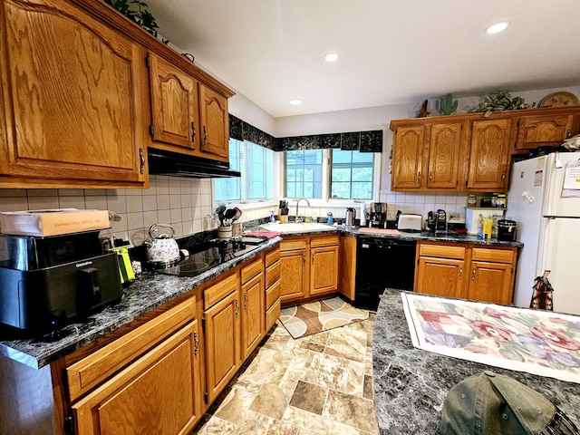 9726 County Road 8530, West Plains, MO 65775 - kitchen with black appliances, under cabinet range hood, a sink, decorative backsplash, and brown cabinetry