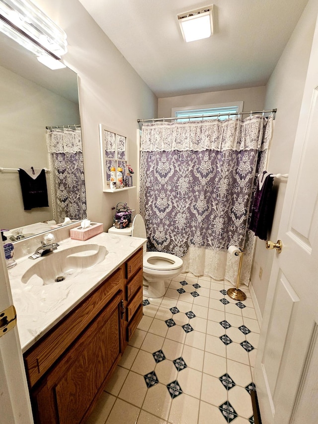 9726 County Road 8530, West Plains, MO 65775 - bathroom featuring vanity, toilet, tile patterned floors, and a shower with curtain