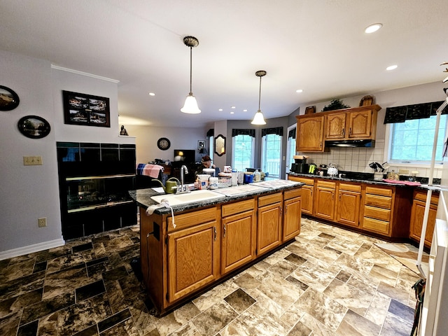 9726 County Road 8530, West Plains, MO 65775 - kitchen featuring a sink, healthy amount of natural light, under cabinet range hood, a center island with sink, and recessed lighting
