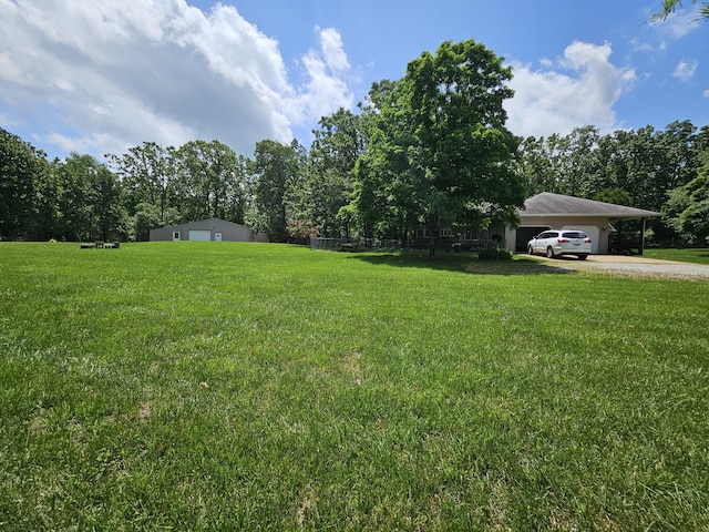 9726 County Road 8530, West Plains, MO 65775 - view of green lawn featuring gravel driveway, a carport, and a garage