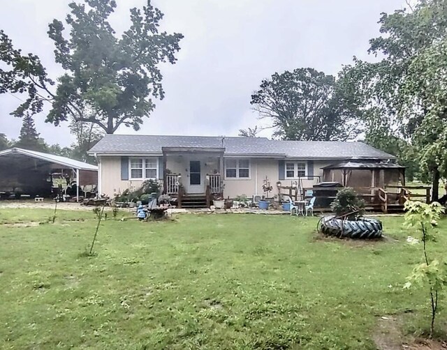 160 Clark St, Taneyville, MO 65759 - rear view of house featuring a gazebo, a yard, and a carport