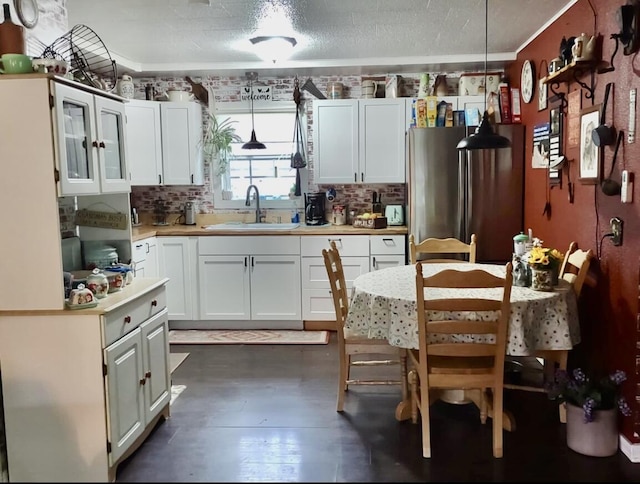 160 Clark St, Taneyville, MO 65759 - kitchen with a sink, freestanding refrigerator, light countertops, backsplash, and white cabinets