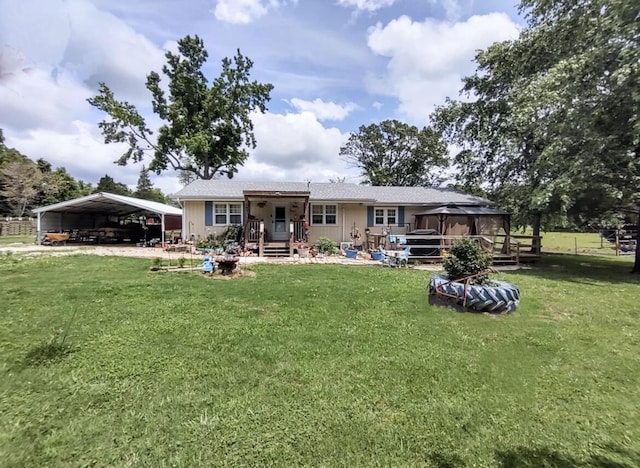 160 Clark St, Taneyville, MO 65759 - rear view of property featuring a carport, a lawn, and a wooden deck