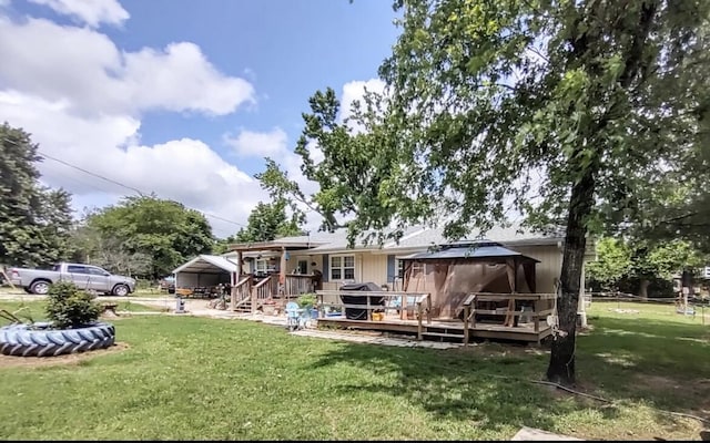 160 Clark St, Taneyville, MO 65759 - rear view of house featuring a gazebo, a deck, and a lawn