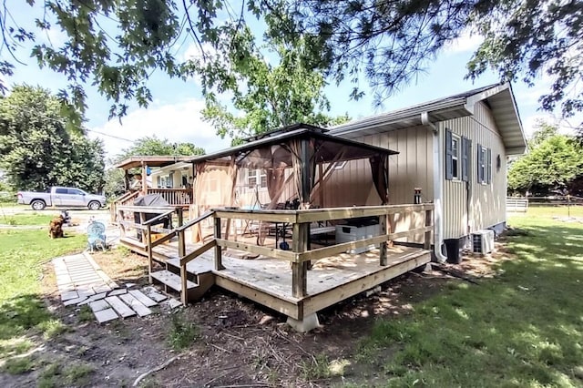 160 Clark St, Taneyville, MO 65759 - back of property with a lawn, a wooden deck, and central AC
