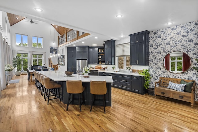 95 Highland Ct, Strafford, MO 65757 - kitchen with ceiling fan, light countertops, stainless steel fridge with ice dispenser, light wood finished floors, and wallpapered walls
