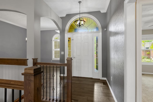 4972 E Cherry Cir, Springfield, MO 65809 - entrance foyer with arched walkways, baseboards, crown molding, a chandelier, and wood finished floors