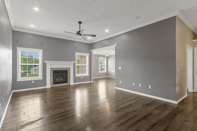 4972 E Cherry Cir, Springfield, MO 65809 - unfurnished living room featuring a ceiling fan, a tiled fireplace, dark wood finished floors, a textured ceiling, and recessed lighting