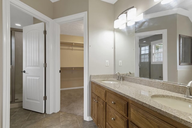 4972 E Cherry Cir, Springfield, MO 65809 - full bath featuring tile patterned flooring, double vanity, a spacious closet, and a stall shower