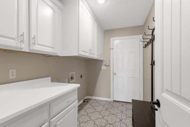 4972 E Cherry Cir, Springfield, MO 65809 - laundry area featuring cabinet space, electric dryer hookup, baseboards, washer hookup, and a textured ceiling