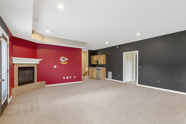 4972 E Cherry Cir, Springfield, MO 65809 - unfurnished living room featuring baseboards, recessed lighting, a fireplace, light colored carpet, and a sink
