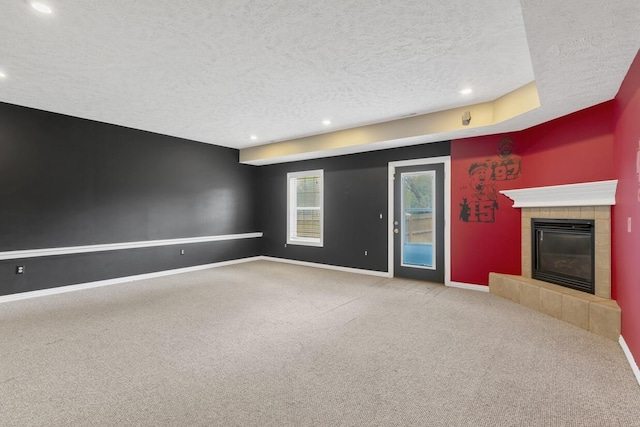 4972 E Cherry Cir, Springfield, MO 65809 - unfurnished living room with a textured ceiling, carpet flooring, baseboards, a fireplace, and recessed lighting