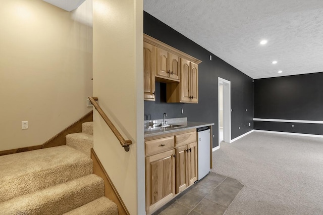4972 E Cherry Cir, Springfield, MO 65809 - kitchen with carpet floors, a sink, light brown cabinetry, baseboards, and dishwasher