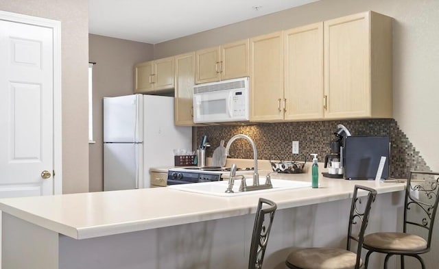 610 Abby Ln Par 61, Branson, MO 65616 - kitchen with white appliances, tasteful backsplash, light countertops, a peninsula, and a breakfast bar