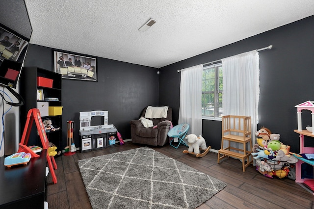 3625 S Moreland Ave, Springfield, MO 65807 - playroom featuring a textured ceiling, wood finished floors, and baseboards