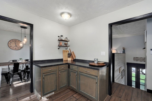 3625 S Moreland Ave, Springfield, MO 65807 - bar area with a textured ceiling, dark wood-style flooring, and a chandelier