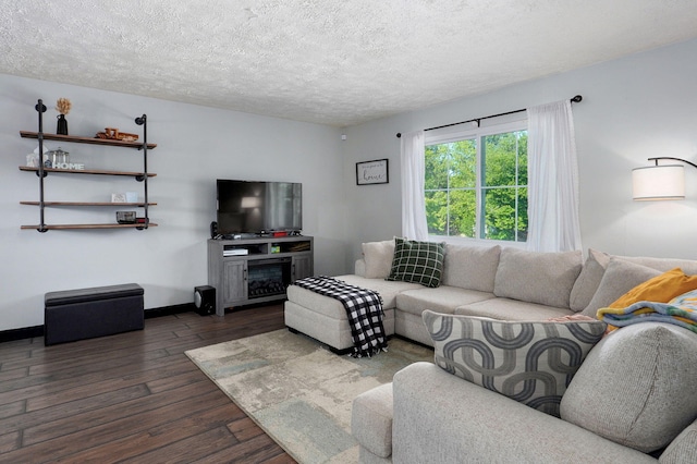 3625 S Moreland Ave, Springfield, MO 65807 - living room with dark wood-style floors, a textured ceiling, baseboards, and a fireplace