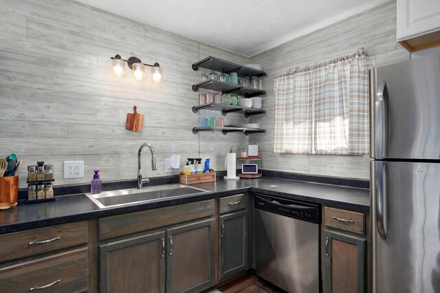 3625 S Moreland Ave, Springfield, MO 65807 - kitchen featuring appliances with stainless steel finishes, a sink, dark countertops, and dark brown cabinets