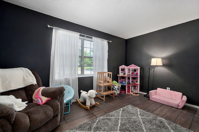 3625 S Moreland Ave, Springfield, MO 65807 - rec room with wood finished floors, baseboards, and a textured ceiling