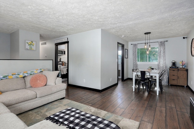 3625 S Moreland Ave, Springfield, MO 65807 - living room with dark wood-type flooring, baseboards, and a textured ceiling
