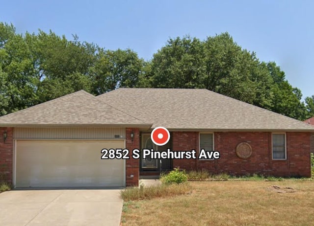 2852 S Pinehurst Ave, Springfield, MO 65807 - ranch-style house featuring an attached garage, brick siding, concrete driveway, and a shingled roof