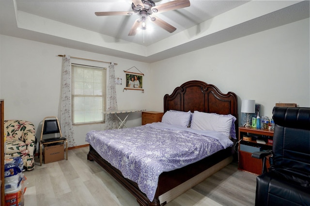 2852 S Pinehurst Ave, Springfield, MO 65807 - bedroom featuring a raised ceiling, light wood finished floors, and a ceiling fan