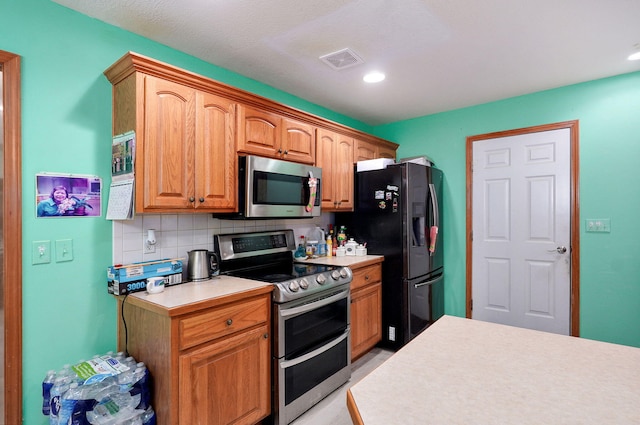 2852 S Pinehurst Ave, Springfield, MO 65807 - kitchen with appliances with stainless steel finishes, light countertops, tasteful backsplash, and recessed lighting