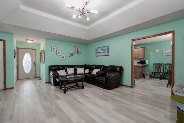 2852 S Pinehurst Ave, Springfield, MO 65807 - living area with a chandelier, light wood finished floors, and a tray ceiling