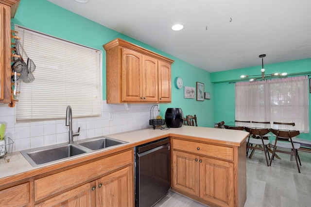2852 S Pinehurst Ave, Springfield, MO 65807 - kitchen featuring dishwasher, a peninsula, decorative backsplash, light countertops, and light wood-style floors