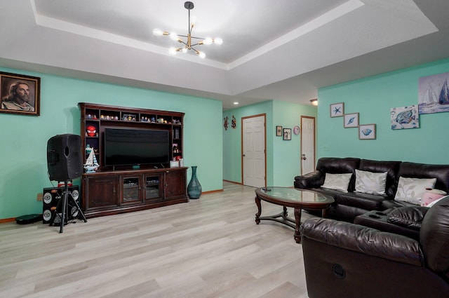 2852 S Pinehurst Ave, Springfield, MO 65807 - living room featuring a tray ceiling, wood finished floors, and a chandelier