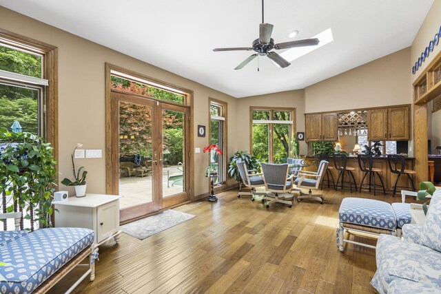 2212 E Nottingham St, Springfield, MO 65804 - sitting room featuring french doors, vaulted ceiling, a ceiling fan, light wood-type flooring, and a skylight