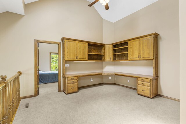 2212 E Nottingham St, Springfield, MO 65804 - unfurnished office featuring high vaulted ceiling, built in desk, light colored carpet, a ceiling fan, and baseboards