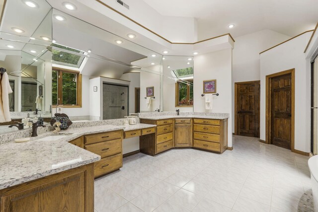 2212 E Nottingham St, Springfield, MO 65804 - bathroom with recessed lighting, two vanities, a shower with shower door, and a towering ceiling