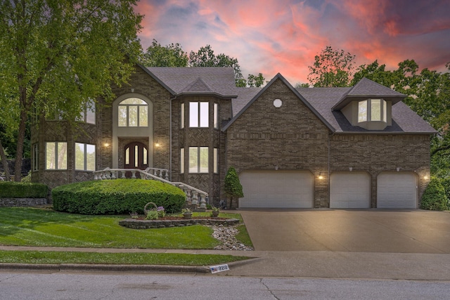 2212 E Nottingham St, Springfield, MO 65804 - view of front of home with driveway, a lawn, and brick siding
