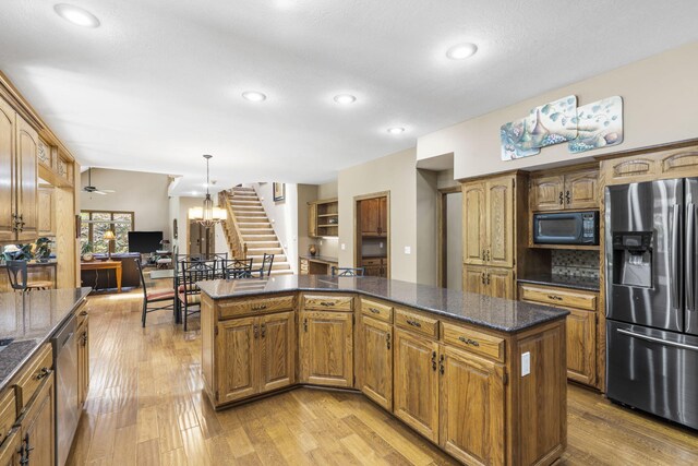 2212 E Nottingham St, Springfield, MO 65804 - kitchen with stainless steel appliances, light wood finished floors, recessed lighting, a kitchen island, and pendant lighting