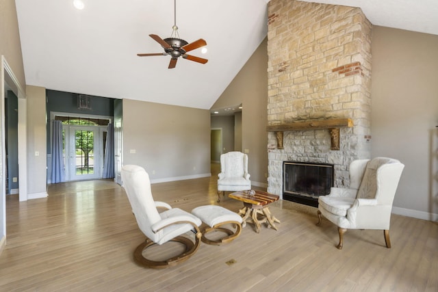 5072 E Hedgerow Dr, Springfield, MO 65802 - sitting room featuring high vaulted ceiling, a stone fireplace, a ceiling fan, wood finished floors, and baseboards