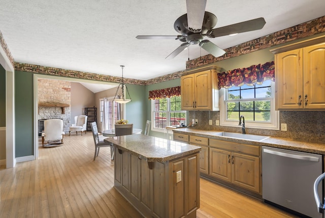 5072 E Hedgerow Dr, Springfield, MO 65802 - kitchen with stainless steel dishwasher, a sink, a center island, backsplash, and tile countertops