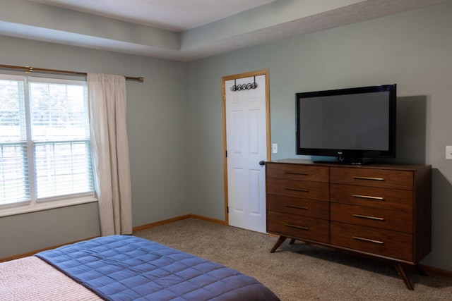 1585 S Mission Ave, Bolivar, MO 65613 - carpeted bedroom featuring multiple windows and baseboards
