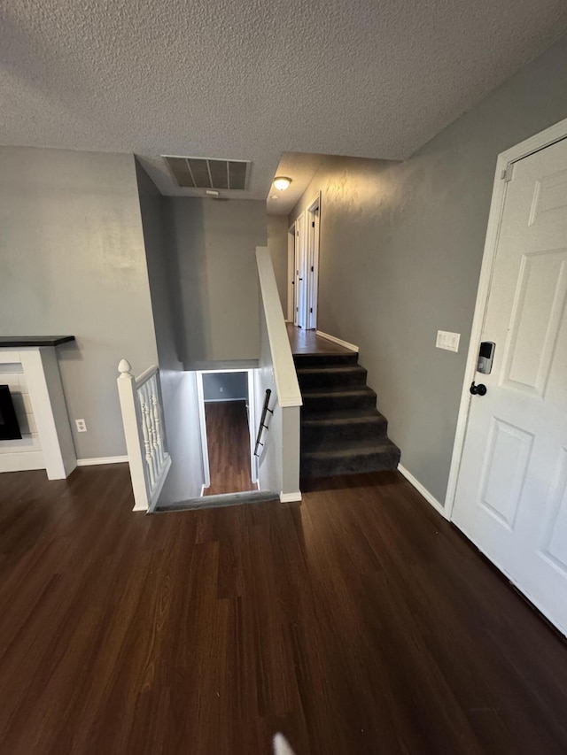 2201 S 14th St, Ozark, MO 65721 - stairway with wood finished floors, a textured ceiling, and baseboards