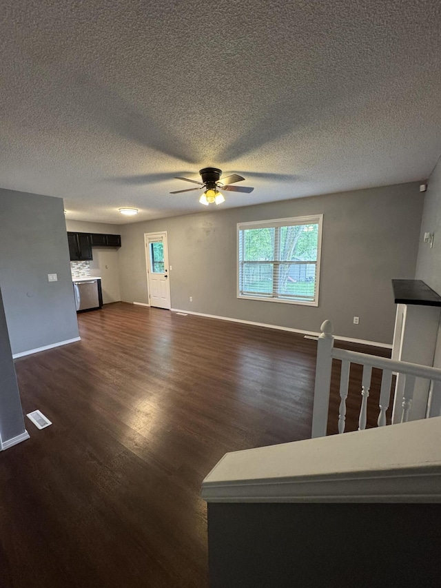 2201 S 14th St, Ozark, MO 65721 - unfurnished living room with ceiling fan, dark wood-style floors, baseboards, and a textured ceiling