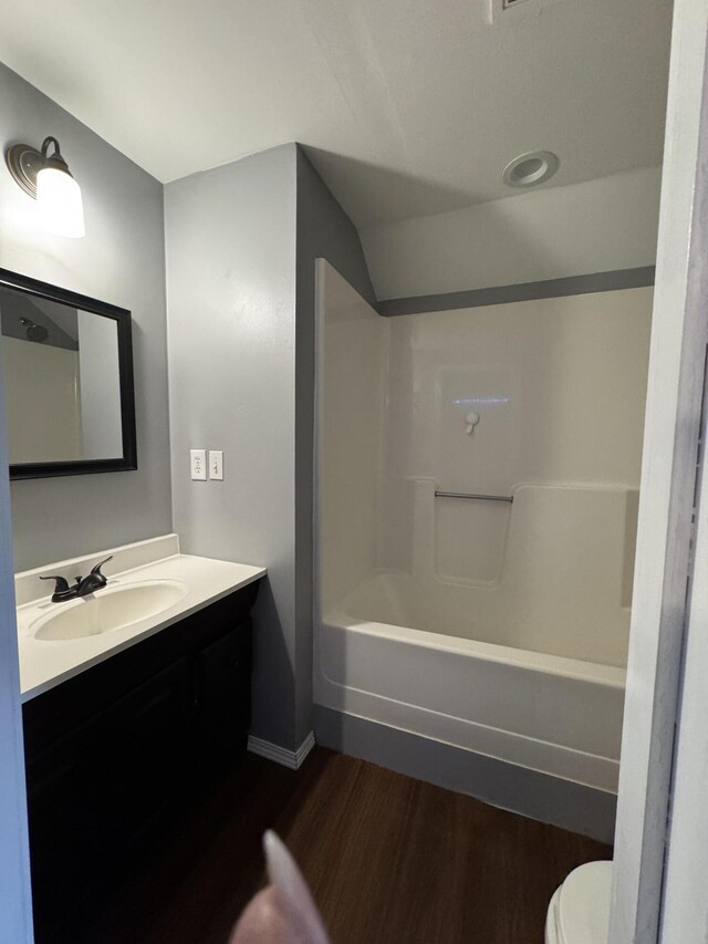 2201 S 14th St, Ozark, MO 65721 - bathroom with wood finished floors, toilet, vanity, baseboards, and bathing tub / shower combination