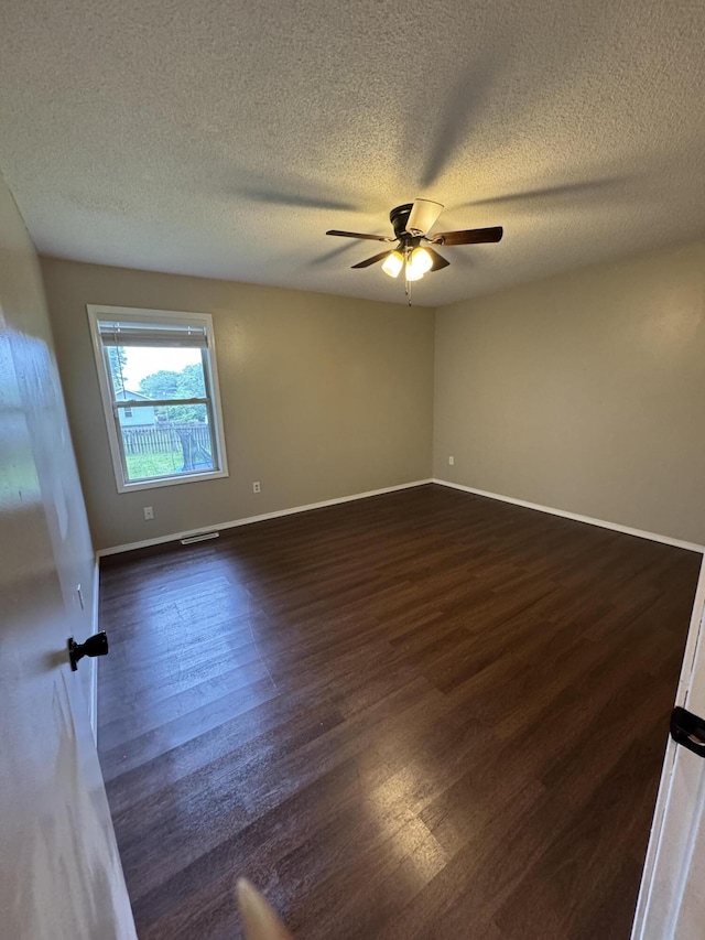 2201 S 14th St, Ozark, MO 65721 - empty room featuring dark wood-style floors, ceiling fan, a textured ceiling, and baseboards