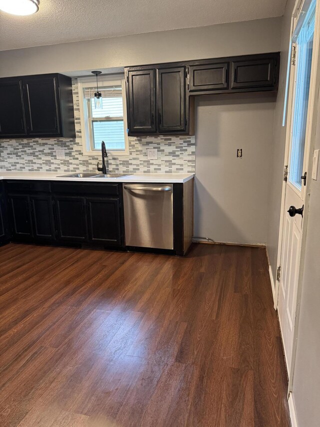 2201 S 14th St, Ozark, MO 65721 - kitchen featuring stainless steel dishwasher, a sink, dark cabinetry, dark wood finished floors, and tasteful backsplash