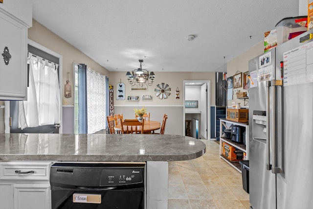 1650 Clouse Rd, Macomb, MO 65702 - kitchen featuring stainless steel fridge with ice dispenser, a chandelier, a peninsula, white cabinetry, and a textured ceiling