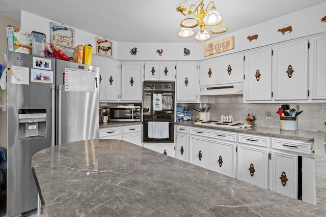 1650 Clouse Rd, Macomb, MO 65702 - kitchen featuring appliances with stainless steel finishes, under cabinet range hood, a chandelier, white cabinets, and a textured ceiling