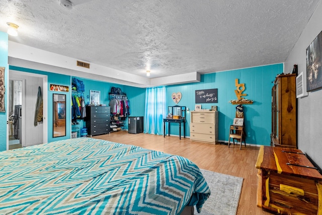 1650 Clouse Rd, Macomb, MO 65702 - bedroom with a textured ceiling and wood finished floors