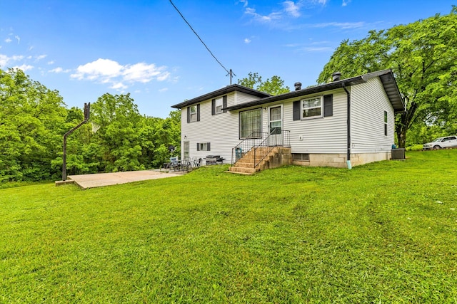 1650 Clouse Rd, Macomb, MO 65702 - rear view of house featuring a patio, a yard, and central AC unit