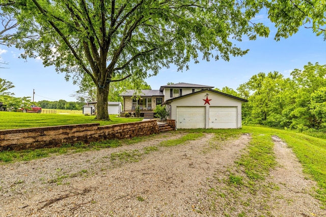 1650 Clouse Rd, Macomb, MO 65702 - tri-level home with driveway, a garage, a front lawn, and covered porch