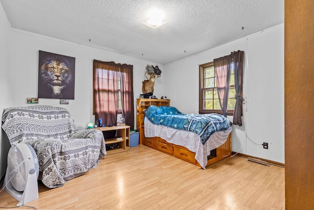 1650 Clouse Rd, Macomb, MO 65702 - bedroom featuring a textured ceiling and wood finished floors